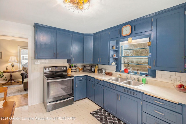 kitchen with blue cabinetry, sink, tasteful backsplash, and black range with electric cooktop