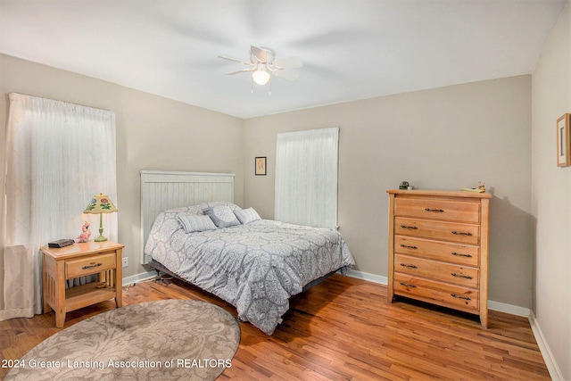 bedroom with light hardwood / wood-style floors and ceiling fan