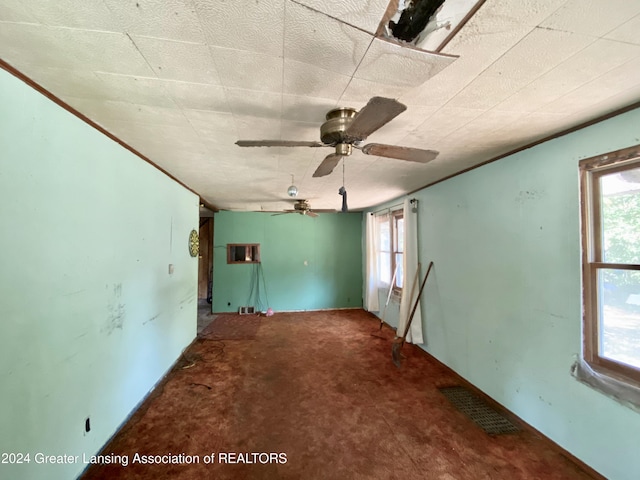 empty room with carpet floors and ceiling fan