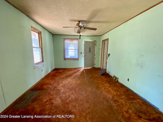 carpeted spare room with ceiling fan