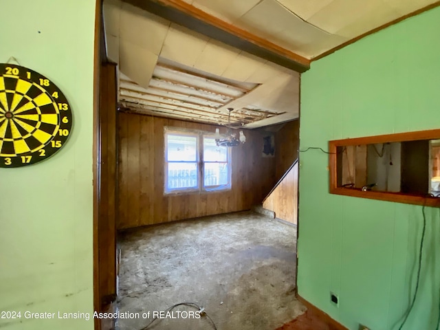 empty room with wooden walls and concrete floors