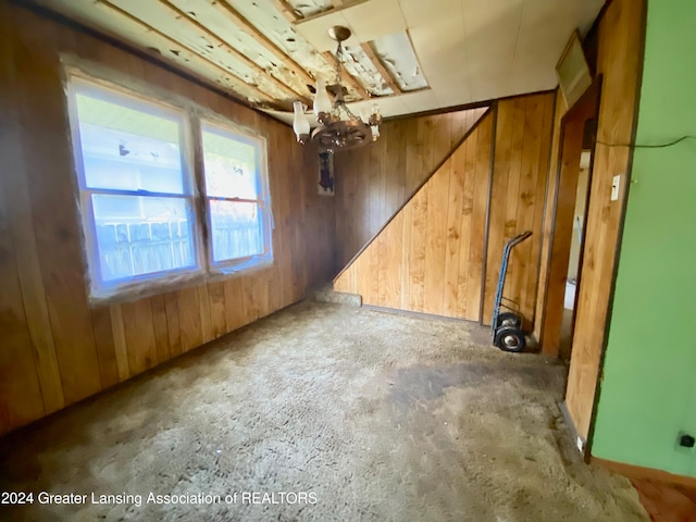 spare room with wooden walls and concrete floors