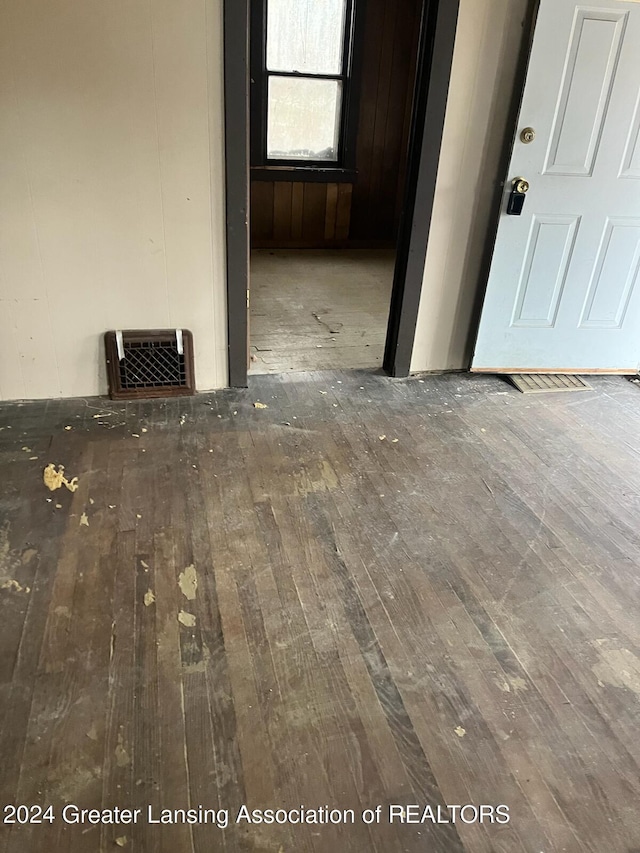 unfurnished room with dark wood-type flooring