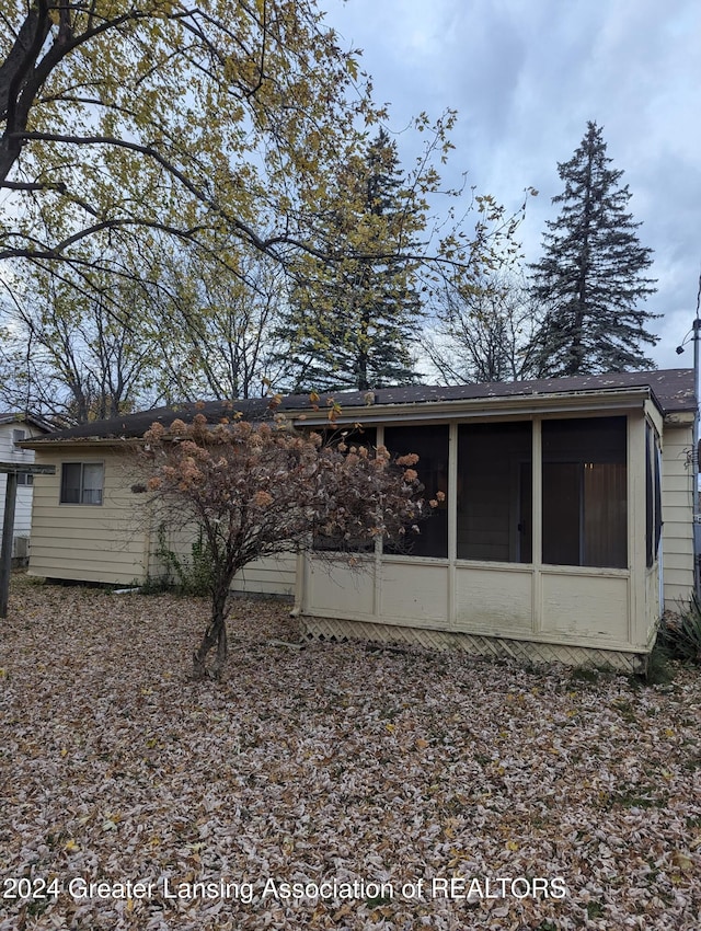 back of house featuring a sunroom