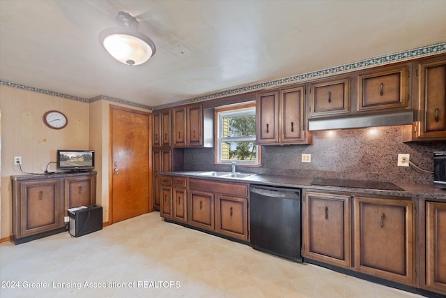 kitchen with decorative backsplash, sink, and black appliances