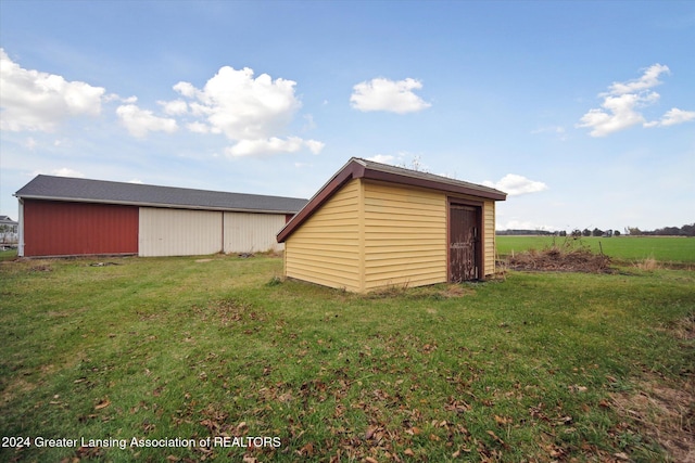 view of outdoor structure featuring a lawn