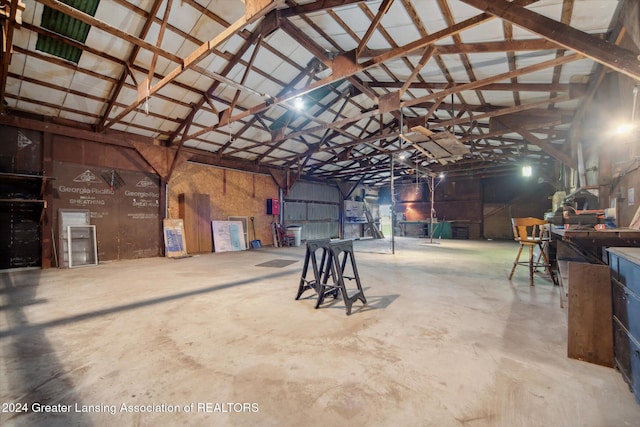 misc room featuring concrete floors and vaulted ceiling