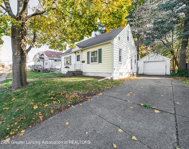 view of front facade with an outbuilding, a front yard, and a garage