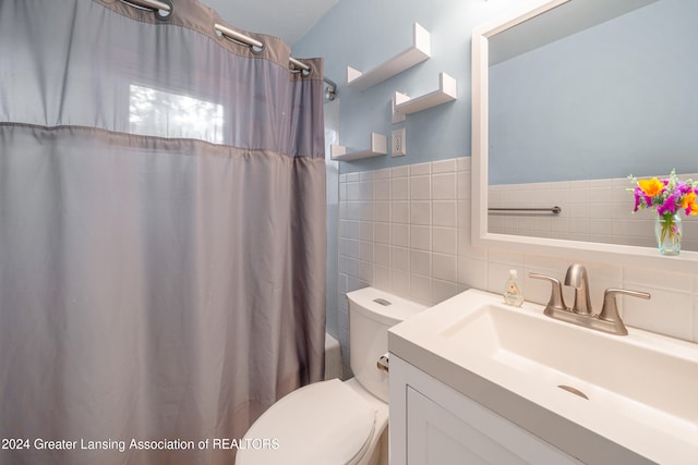 full bathroom featuring vanity, toilet, shower / bathtub combination with curtain, and tile walls