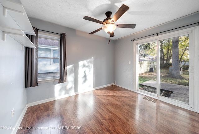 spare room featuring hardwood / wood-style floors, ceiling fan, and a textured ceiling