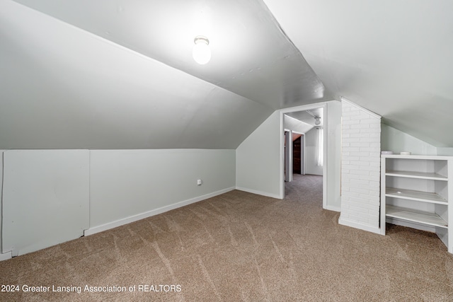 bonus room with carpet floors and lofted ceiling