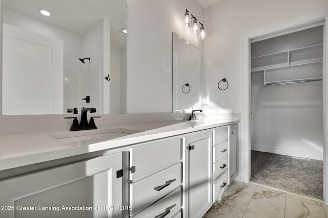 bathroom with vanity and a shower