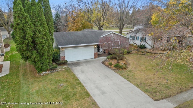 view of front of house featuring a front yard and a garage