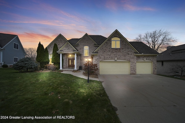 view of front of home featuring a lawn and a garage