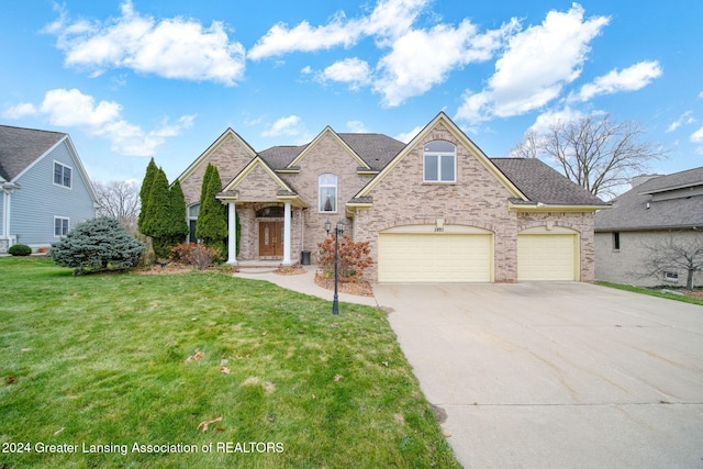 view of front of house with a front lawn and a garage