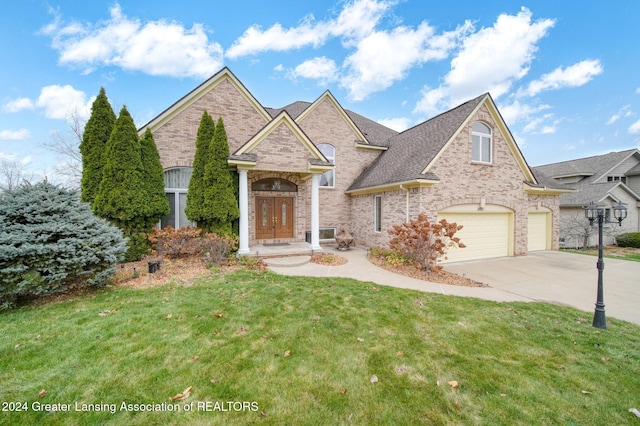 view of front of property with a front yard and a garage