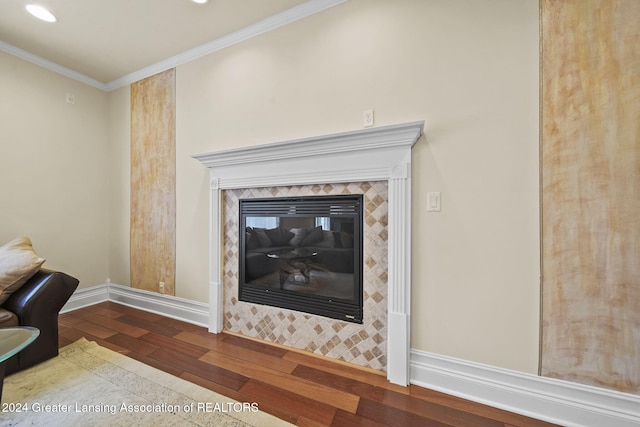 interior details featuring crown molding, a fireplace, and wood-type flooring