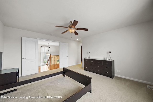 bedroom featuring ceiling fan and light carpet