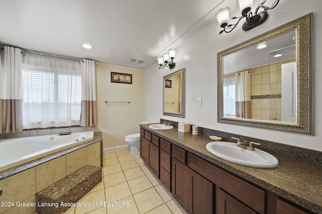 bathroom featuring tiled bath, tile patterned flooring, vanity, and toilet