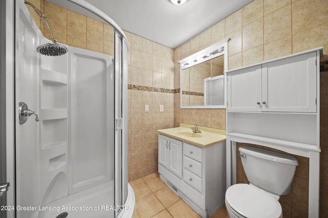 bathroom featuring tile patterned flooring, vanity, tile walls, and an enclosed shower