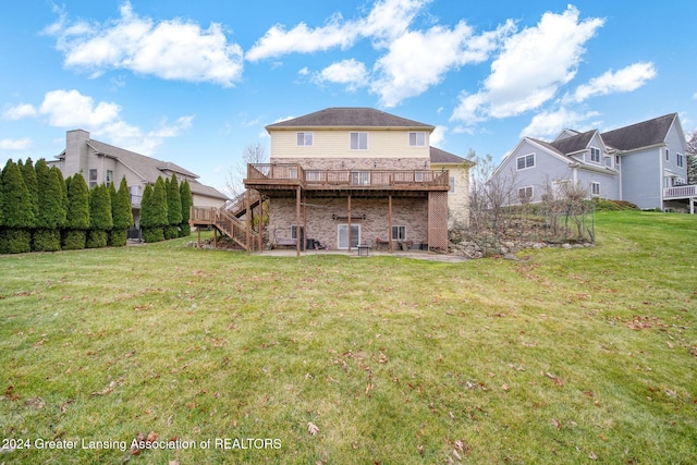 back of house with a yard and a wooden deck