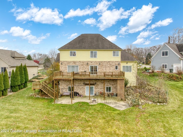 rear view of property with a lawn, a patio area, and a wooden deck