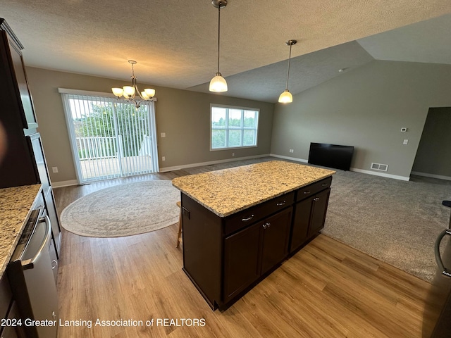 kitchen with light stone countertops, light wood-type flooring, dark brown cabinetry, and vaulted ceiling