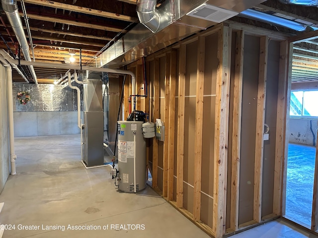 basement featuring heating unit and water heater