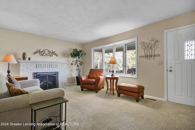 living room with carpet floors and a fireplace