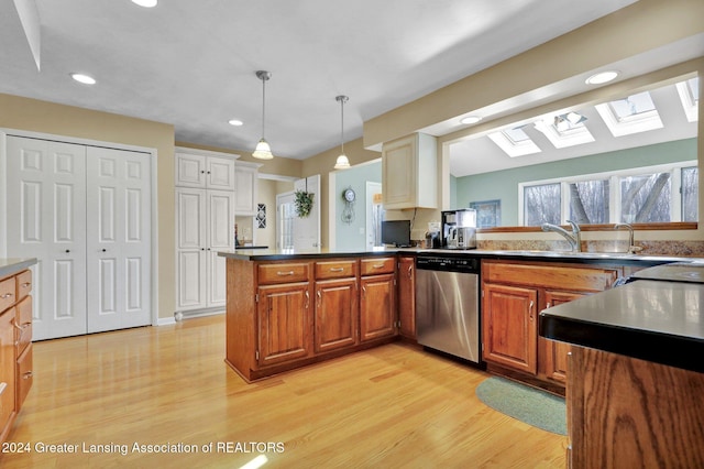 kitchen with dishwasher, sink, kitchen peninsula, light hardwood / wood-style floors, and decorative light fixtures