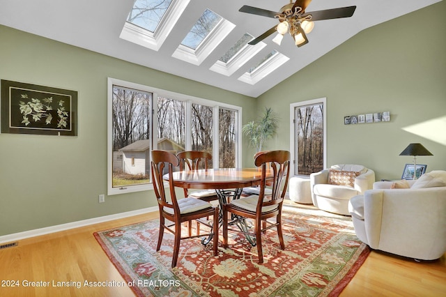 dining area featuring ceiling fan, light hardwood / wood-style floors, and lofted ceiling