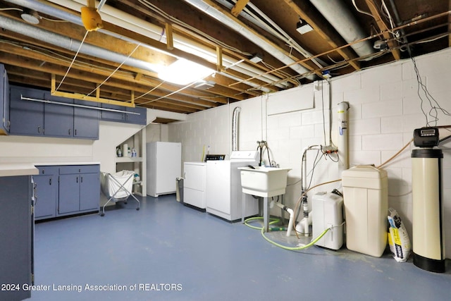 basement with washing machine and dryer and sink