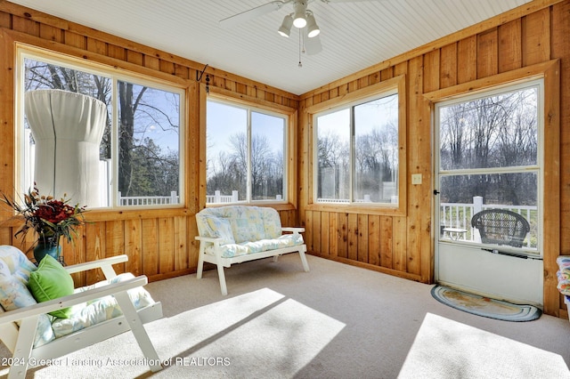 sunroom / solarium featuring ceiling fan