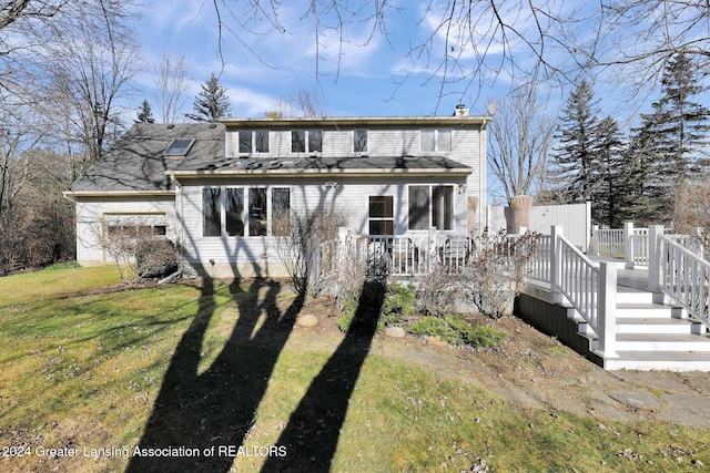 back of house with a yard and a deck