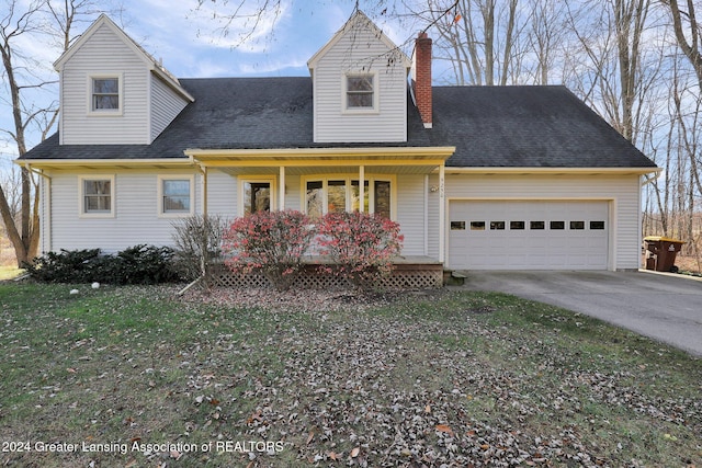 new england style home featuring a porch and a front lawn