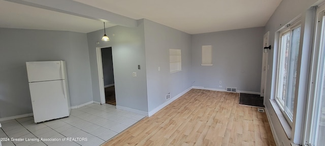 spare room with light hardwood / wood-style flooring