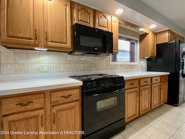 kitchen featuring black appliances, light tile patterned floors, and backsplash