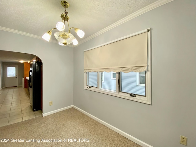 carpeted empty room with a healthy amount of sunlight, ornamental molding, and a textured ceiling