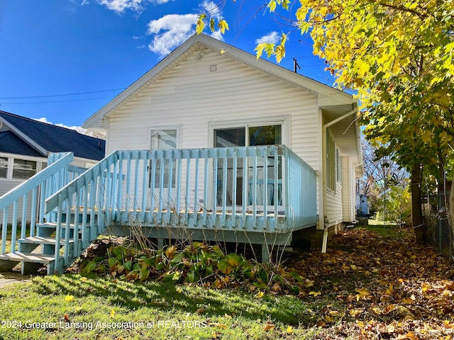 rear view of property with a wooden deck