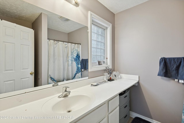 bathroom featuring vanity and a textured ceiling