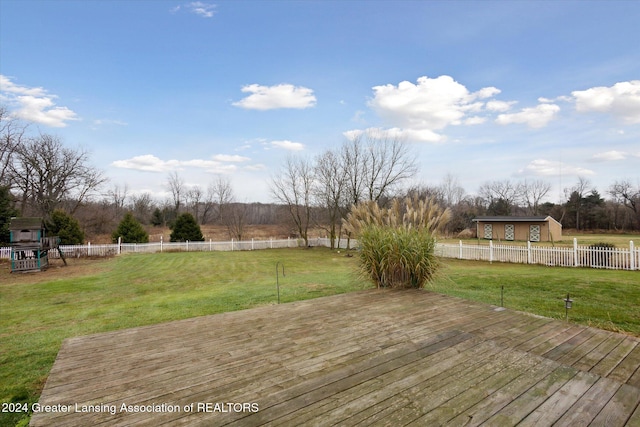 deck with a rural view and a lawn