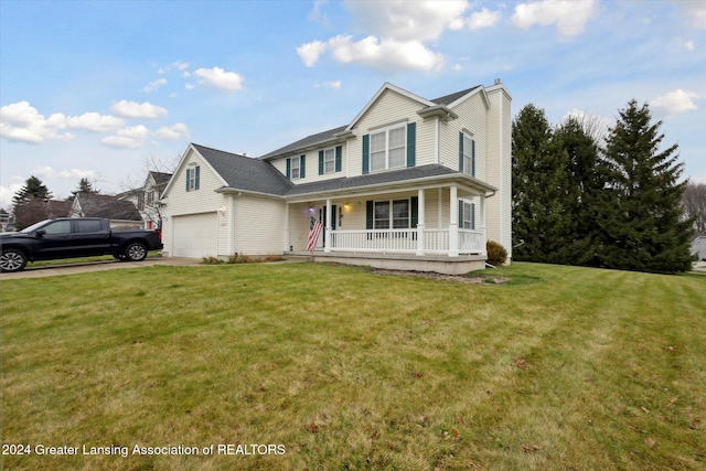 view of front of home featuring covered porch, a garage, and a front lawn