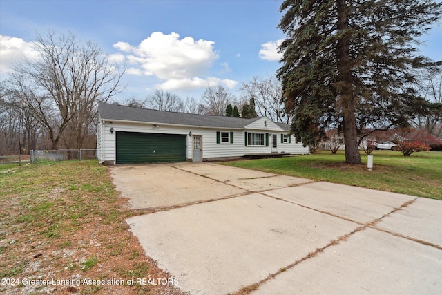 ranch-style house featuring a front lawn and a garage