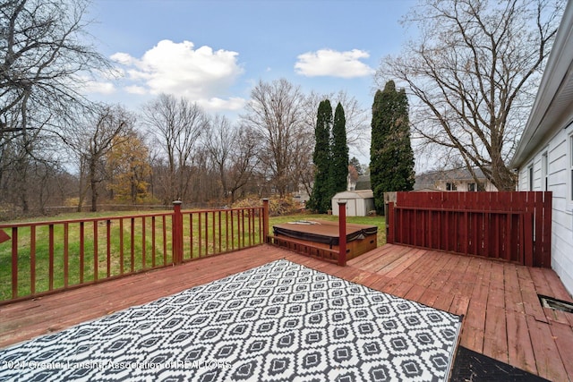 wooden terrace featuring a lawn and a shed