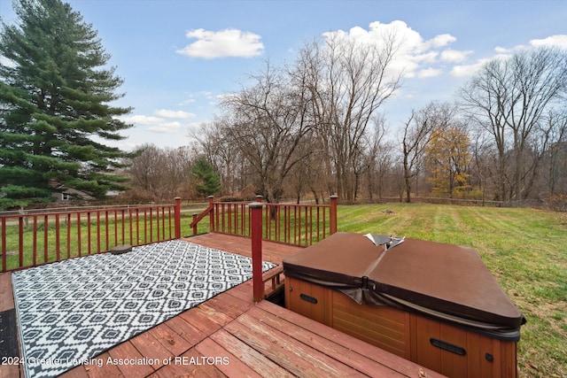 deck featuring a lawn and a hot tub