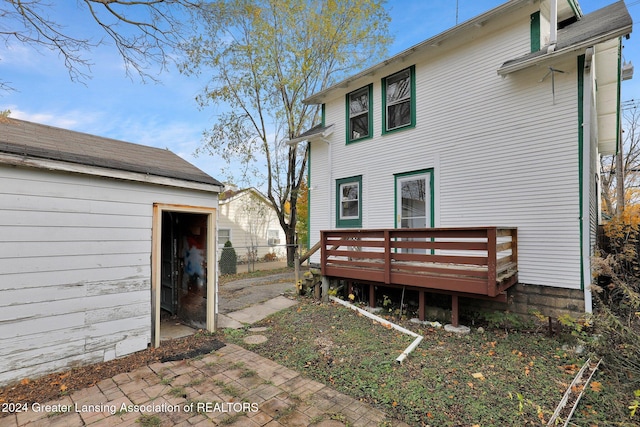 rear view of house with a wooden deck