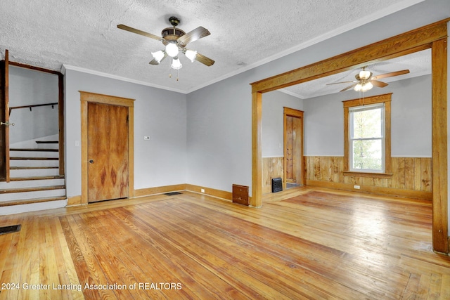 unfurnished living room with a textured ceiling, light wood-type flooring, and ceiling fan