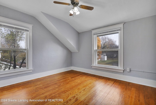 bonus room with hardwood / wood-style floors, vaulted ceiling, and plenty of natural light