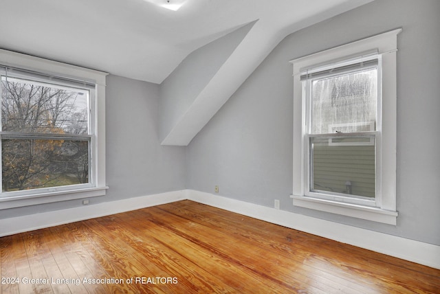 bonus room with wood-type flooring and lofted ceiling