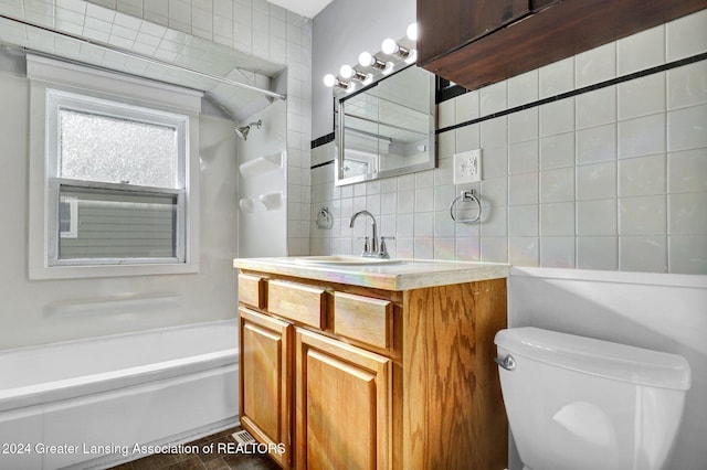 full bathroom featuring decorative backsplash, vanity, washtub / shower combination, and toilet